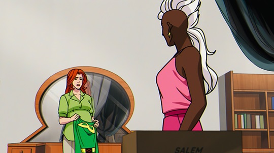 Tempestade e Jean, em roupas casuais, se encaram. Jean está segurando um uniforme antigo de batalha na frente da barriga, que indica sua gravidez.