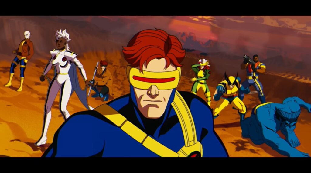 Ciclope em destaque, com os outros X-Men atrás dele, em posição de batalha, em meio a um deserto.