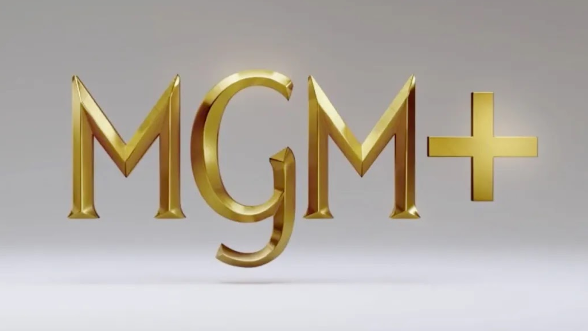 Logo MGM+ em dourado com fundo cinza