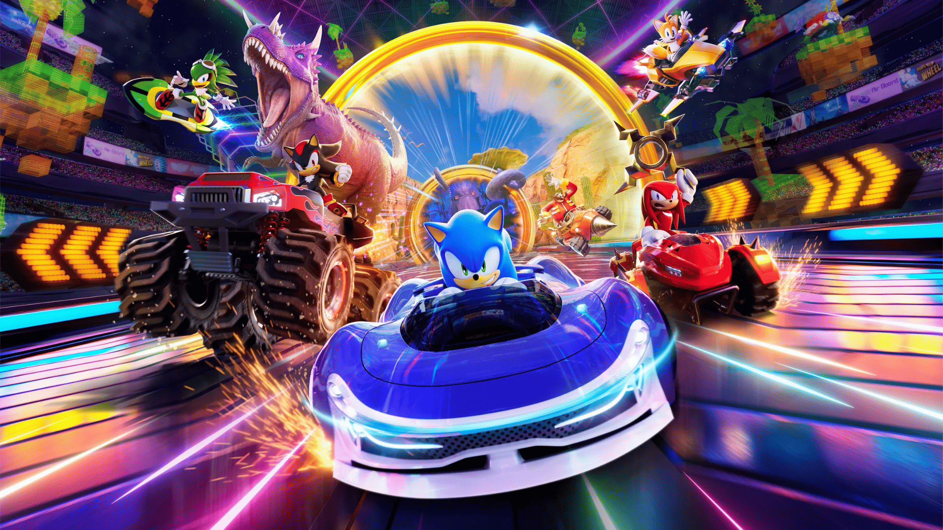 Uma imagem vibrante mostra várias personagens do universo Sonic Racing: CrossWorlds participando de uma corrida futurista e colorida. No centro, Sonic the Hedgehog está em um elegante carro de corrida azul e branco, olhando diretamente para frente com determinação. À sua esquerda, um dinossauro tiranossauro rex gigante, pilotado por Shadow the Hedgehog, dirige um monster truck vermelho massivo, com a boca aberta em um rugido. Atrás do monster truck, Vector the Crocodile está em um veículo menor e ágil. No lado direito da imagem, Knuckles the Echidna está em um carro de corrida vermelho, com uma expressão séria. Mais ao fundo, à direita, Tails the Fox voa em um veículo aéreo, e Amy Rose está em outro carro de corrida. O cenário da corrida é uma mistura de elementos, incluindo uma pista futurista com luzes de néon, uma arquibancada lotada à esquerda e palmeiras ao fundo, sugerindo um ambiente tropical. No centro superior da imagem, um grande anel dourado com nuvens e um sol poente pode ser visto, talvez indicando um portal ou um ponto focal. As cores predominantes são azuis, rosas, roxos e laranjas brilhantes, com linhas de velocidade indicando movimento rápido.